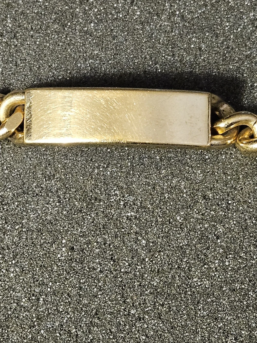 Vintage gold-tone curb-link ID bracelet signed SWANK on the Back identification